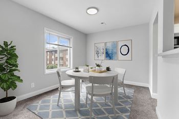 A dining room with a table and chairs 